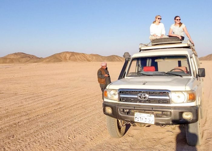 Une Magnifique Photo De Deux Filles Assises Sur Un Vehicule Tout Terrain Lors Dun Safari